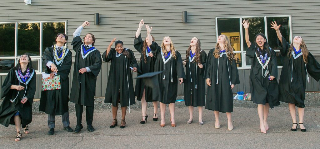 Kids Graduating, throwing their hat up in the air