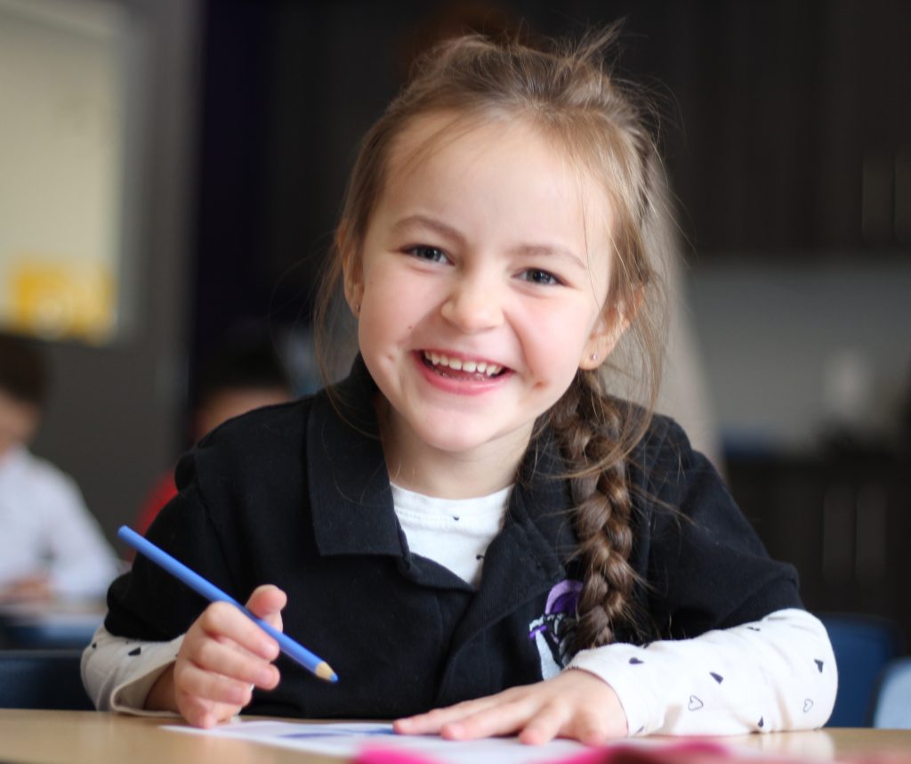 Young Happy Girl at Desk